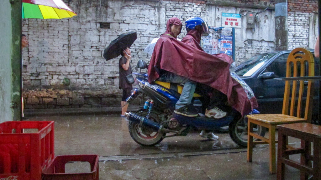 Man in poncho smiles